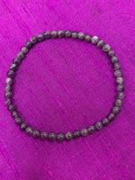 Load image into Gallery viewer, Close-up view. Petite amethyst 4mm power bracelet. Tiny and mighty, this bracelet puts the power of amethyst right around your wrist. Buy one or wear them and share them - they come in a variety of gemstone choices.
