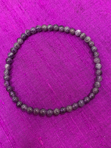 Close-up view. Petite amethyst 4mm power bracelet. Tiny and mighty, this bracelet puts the power of amethyst right around your wrist. Buy one or wear them and share them - they come in a variety of gemstone choices.