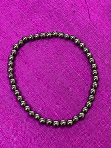Close-up view. Hematite gemstone power bracelet. Bead size is 4mm. Tiny but mighty, this bracelet puts the power of hematite right around your wrist. Buy one or buy a bunch and wear and share with family and friends - we have a variety of gemstone bracelet choices.