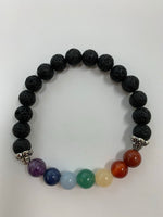 Load image into Gallery viewer, Close-up view. Lava power bracelet with seven chakra stones and embellished with two silver-colored (not sterling) accent beads. Lava is very grounding, calming and protective. The bead size is 8mm.

