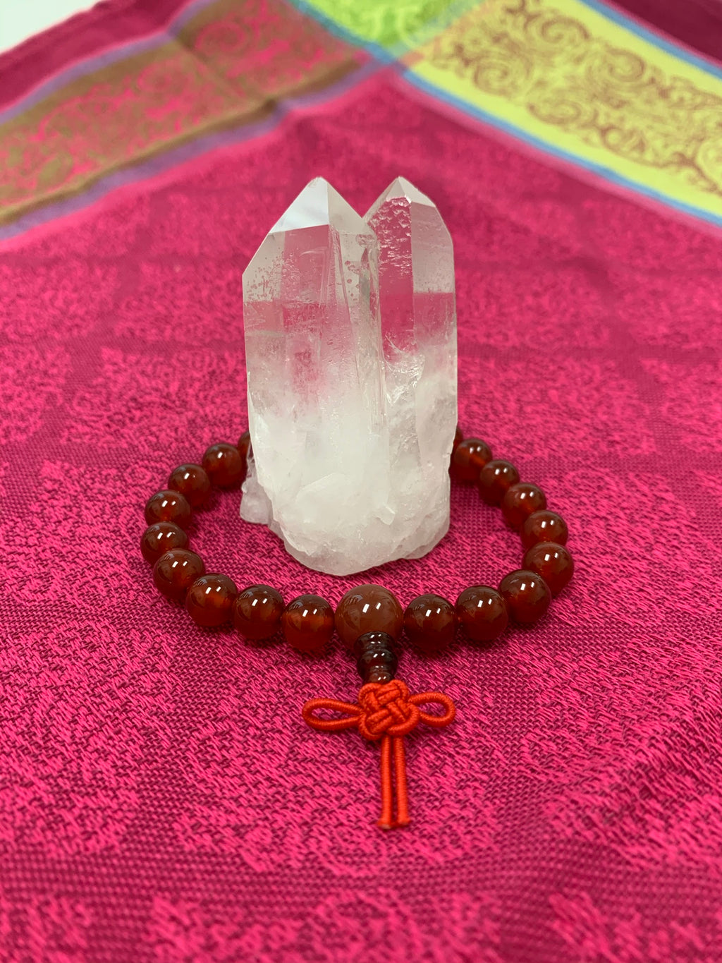 Carnelian power bracelet accented with red Chinese tassel knot. Beads are 8 mm. Carnelian promotes courage, creativity, vitality and dispels emotional negativity.