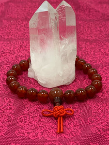 Second close-up view. Carnelian power bracelet accented with red Chinese tassel knot. Beads are 8 mm. Carnelian promotes courage, creativity, vitality and dispels emotional negativity.