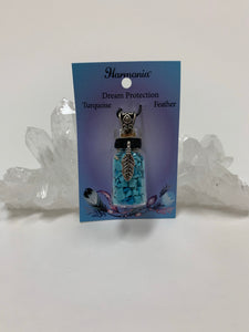 Gemstone (corked) chip bottle necklace with little turquoise chips inside, accented by a silver-colored feather and fancy jewelry bail on the outside. Silver is not sterling. Thin suede cord is included to be used as a necklace.