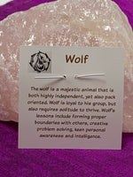 Load image into Gallery viewer, Information about wolf and its lessons, printed on the back of the pendant card, are included with your purchase of the wolf spirit animal pendant.
