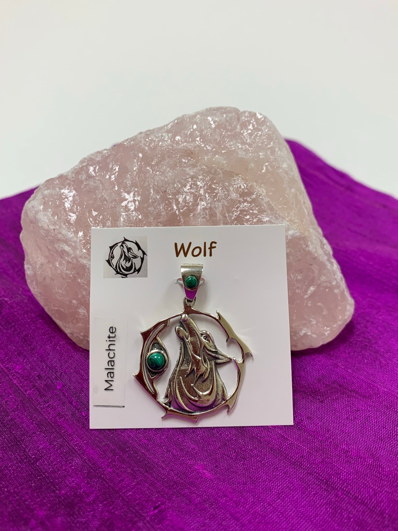 Sterling Silver wolf spirit animal pendant. Howling wolf (head and part of body) inside a fancy, stylized circle. Two malachite gemstones (cabs), one on the actual pendant and one on the bail. Wear your spirit animal on your chest and carry it with you wherever you go! (Pendant only, no necklace chain).
