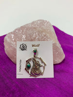 Load image into Gallery viewer, Sterling Silver wolf spirit animal pendant. Howling wolf (head and part of body) inside a fancy, stylized circle. Two malachite gemstones (cabs), one on the actual pendant and one on the bail. Wear your spirit animal on your chest and carry it with you wherever you go! (Pendant only, no necklace chain).
