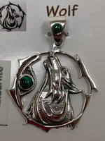 Load image into Gallery viewer, Close-up view of sterling Silver wolf spirit animal pendant. Howling wolf (head and part of body) inside a fancy, stylized circle. Two malachite gemstones (cabs), one on the actual pendant and one on the bail. Wear your spirit animal on your chest and carry it with you wherever you go! (Pendant only, no necklace chain).
