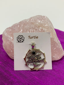 Sterling silver sea turtle spirit animal pendant. The turtle is set inside an open, stylized sterling silver circle. There is a black onyx gemstone (cab) within the circle, above the sea turtle. This is a pendant only, no necklace chain included.  Carry your spirit animal's energy everywhere you go!