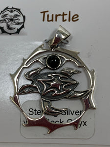 Close-up view of the sterling silver sea turtle spirit animal pendant. The turtle is set inside an open, stylized sterling silver circle. There is a black onyx gemstone (cab) within the circle, above the sea turtle. This is a pendant only, no necklace chain included. Carry your spirit animal's energy everywhere you go!