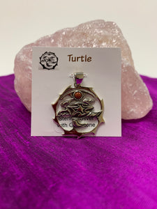 Sterling silver sea turtle spirit animal pendant with goldstone. Sea turtle is set within a stylized silver circle, with the goldstone above it. Where your spirit animal upon your chest so its energy is with you everywhere you go. Pendant only - necklace chain not included.