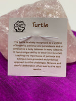 Load image into Gallery viewer, Information about sea turtle and its lessons, printed on the back of the pendant card, are included when you purchase the pendant. 

