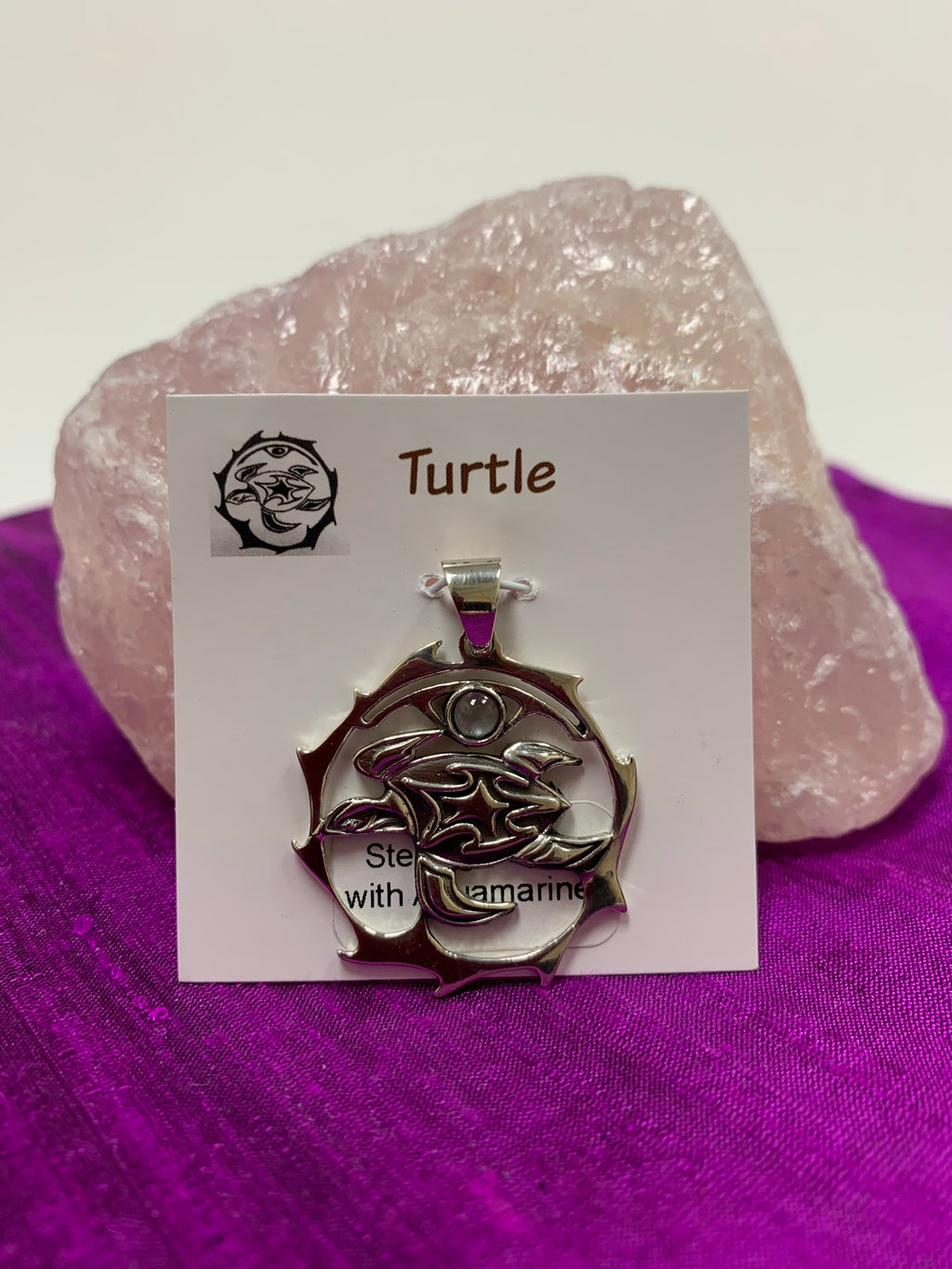 Sterling silver spirit animal, sea turtle, pendant accented with an aquamarine gemstone. Sea turtle is set in an open, sterling silver, circle with the aquamarine above it. Wear your spirit animal so you have it everywhere you go! Pendant only - necklace chain not included. 
