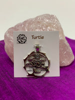 Load image into Gallery viewer, Sterling silver spirit animal, sea turtle, pendant accented with an aquamarine gemstone. Sea turtle is set in an open, sterling silver, circle with the aquamarine above it. Wear your spirit animal so you have it everywhere you go! Pendant only - necklace chain not included. 
