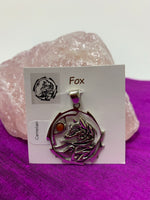 Load image into Gallery viewer, Sterling silver fox animal spirit pendant accented with a carnelian gemstone. The sterling silver fox is set inside an open, stylized sterling silver circle with the carnelian alongside of it. Wear your spirit animal and take its energy everywhere you go! Pendant only - necklace chain not included. 
