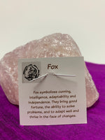 Load image into Gallery viewer, Information about fox and its lessons are printed on the back of the pendant card and included with your purchase of a pendant. 
