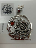 Load image into Gallery viewer, Close-up view. Sterling silver fox animal spirit pendant accented with a carnelian gemstone. The sterling silver fox is set inside an open, stylized sterling silver circle with the carnelian alongside of it. Wear your spirit animal and take its energy everywhere you go! Pendant only - necklace chain not included.
