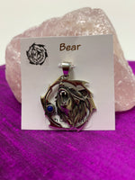 Load image into Gallery viewer, Sterling silver bear animal spirit pendant, accented with lapis gemstone. Bear (mostly head neck area) is set inside an open, stylized circle (bear and circle are sterling). Wear your animal spirit&#39;s energy so you have it with you everywhere you go! Pendant only - necklace chain not included. 
