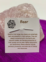 Load image into Gallery viewer, Information about bear energy and its lessons is printed on the back of the pendant card and is included with your purchase of the pendant.
