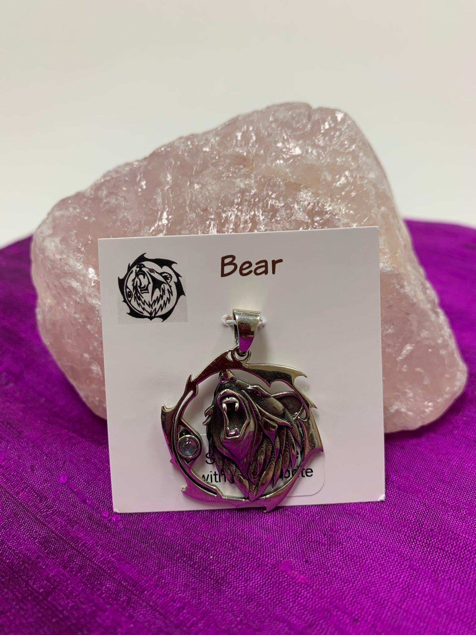 Sterling silver bear animal pendant, accented with a labradorite gemstone. The bear (mostly head neck area) is set within an open, stylized circle with the gemstone along the side (bear and circle both sterling). Wear your animal spirit's energy so you can take it anywhere you go! Pendant only - necklace chain not included.