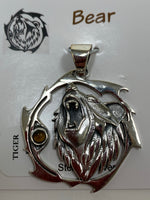 Load image into Gallery viewer, Sterling silver bear animal pendant, accented with a tiger eye gemstone. Bear is set within an open, stylized circle with the gemstone along the side (bear and circle are sterling). Wear your spirit animal&#39;s energy so you have it everywhere you go! Pendant only - necklace chain not included.
