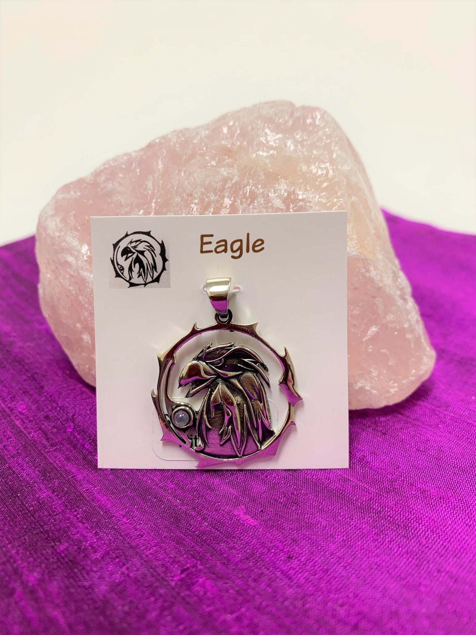 Sterling silver eagle spirit animal pendant, accented with an opal gemstone. Eagle is set within an open, stylized circle with the gemstone along the side (eagle and circle are sterling). Wear this spirit animal so you can feel its energy everywhere you go! Pendant only - necklace chain not included. 