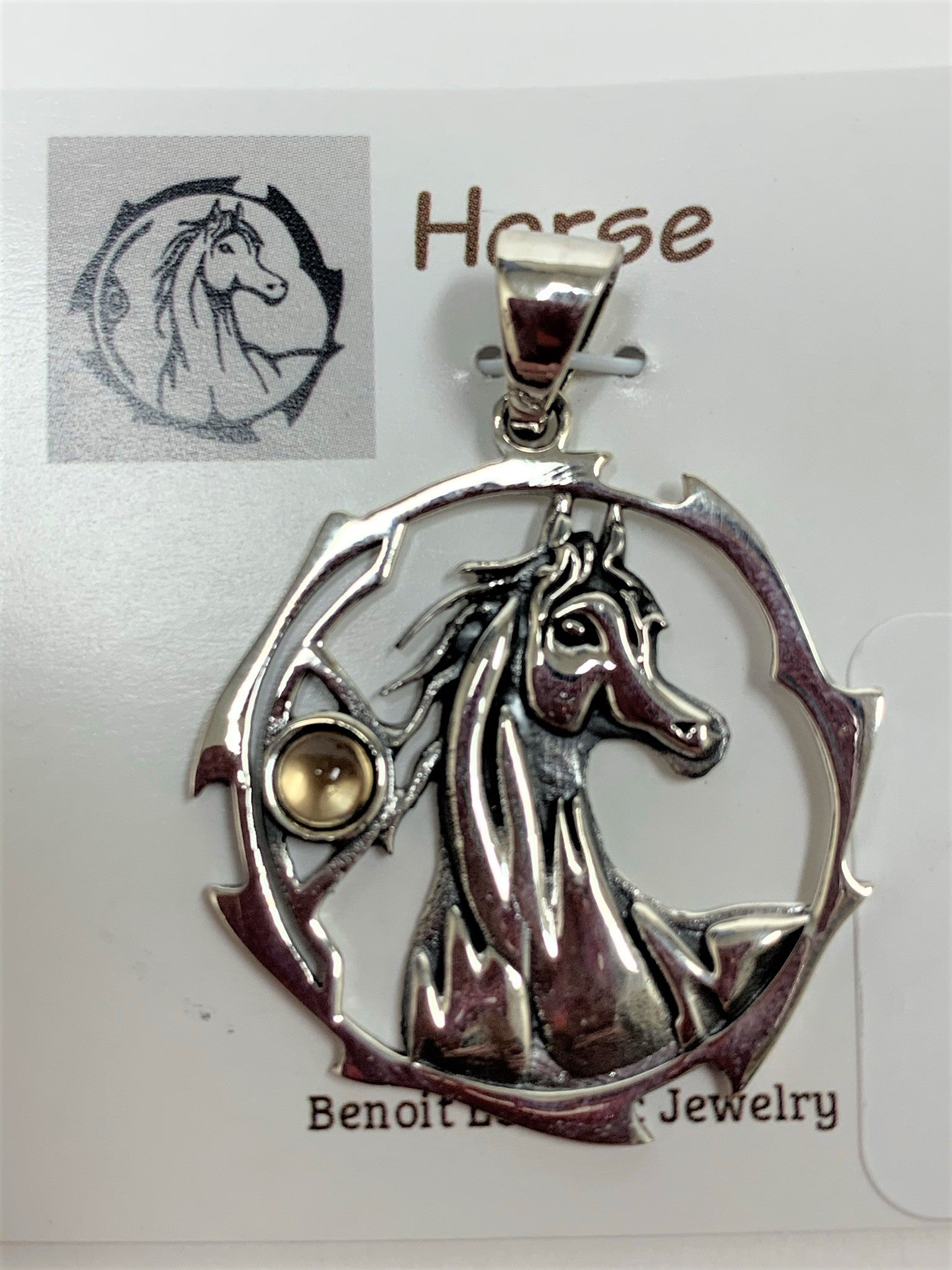 Close-up view. Sterling silver horse spirit animal pendant, accented with a citrine gemstone. The horse is set within an open, stylized circle with the gemstone on the side (horse and circle are sterling). Wear your spirit animal's energy everywhere you go! Pendant only - necklace chain not included.