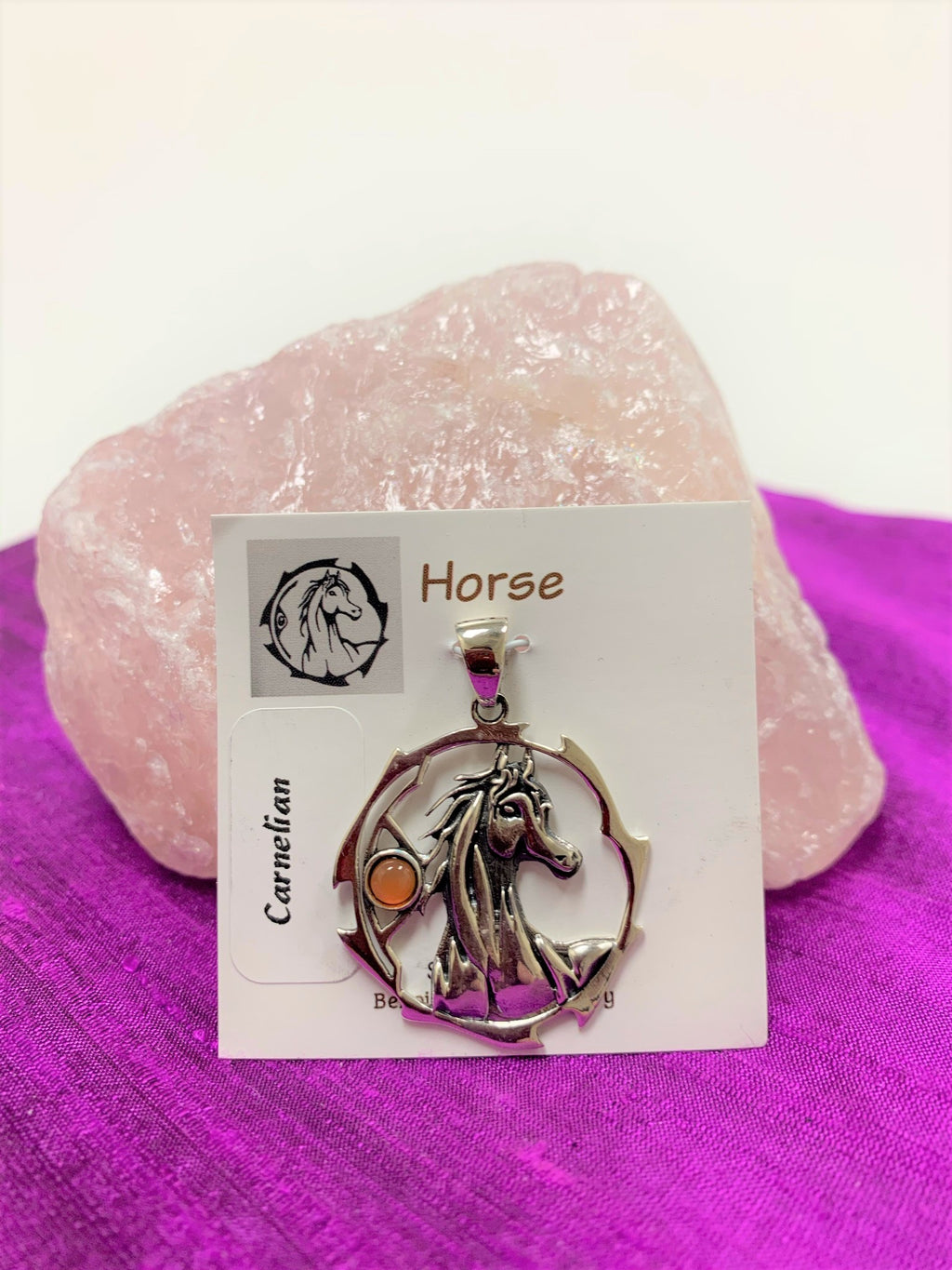 Sterling silver horse spirit animal pendant, accented with a carnelian gemstone. Horse is set within an open, stylized circle with the gemstone on the side (horse and circle are sterling). Wear your spirit animal so you have its energy everywhere you go! Pendant only - necklace chain not included. 