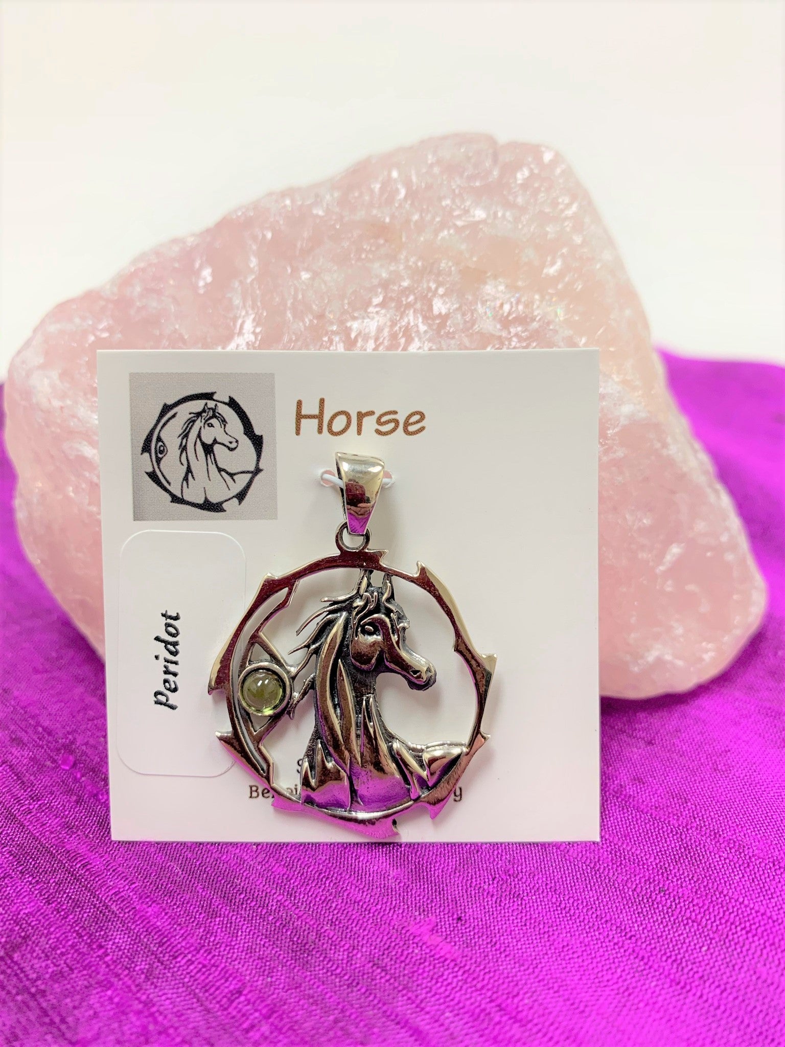 Sterling silver horse spirit animal pendant, accented with a peridot gemstone. Horse is set within an open, stylized circle with the gemstone on the side (horse and circle are sterling). Wear your spirit animal's energy so you will have it with you everywhere you go! Pendant only - necklace chain not included. 