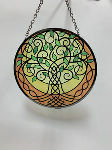 Suncatcher with tree of life design in greens, yellows, gold and black. Beauty and spiritual meaning - sweet combo! Comes with thin chain for hanging and suction cup to hold it.