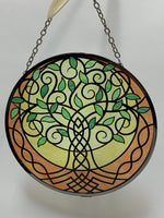 Load image into Gallery viewer, Close-up view. Suncatcher with tree of life design in greens, yellows, gold and black. Beauty and spiritual meaning - sweet combo! Comes with thin chain for hanging and suction cup to hold it.
