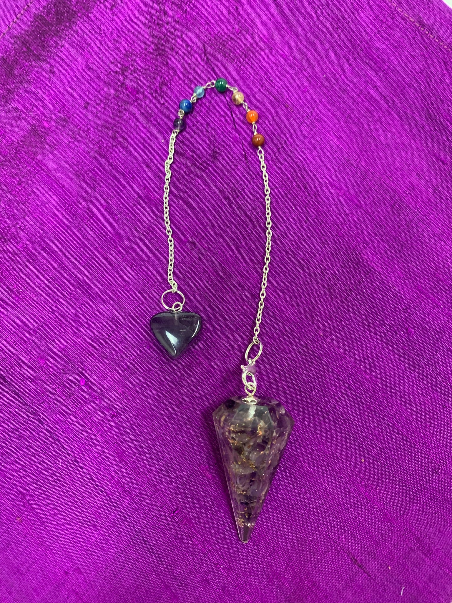 Orgonite pendulum with amethyst, on a thin silver (not sterling) chain, accented by chakra gemstone beads, 1 for each of the 7 major chakras and an amethyst heart at the very end of the chain. 