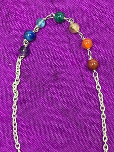 Close-up view of the 7 chakra beads on the pendulum's chain.