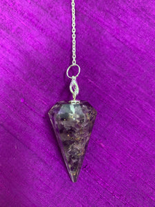 Close-up view. Orgonite pendulum with amethyst, on a thin silver (not sterling) chain, accented by chakra gemstone beads, 1 for each of the 7 major chakras and an amethyst heart at the very end of the chain.