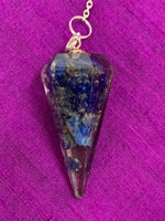 Load image into Gallery viewer, Close up view. Orgonite pendulum with lapis, accented with 7 chakra gemstone beads, on the its chain, 1 for each of the 7 major chakras. Also accented by a lapis gemstone heart at the end of the the pendulum&#39;s chain.
