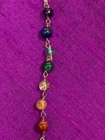 Load image into Gallery viewer, Close-up view of the 7 chakra gemstone beads on the pendulum&#39;s chain.
