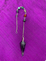 Load image into Gallery viewer, Amethyst pendulum with silver-colored chain (not sterling), accented by 7 gemstone beads, 1 for each of the 7 major chakras. A satiny lined box is included that shows the colors and names of the chakras and also the name of each of the chakra beads. 
