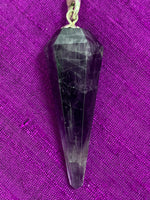 Load image into Gallery viewer, Close-up view of the amethyst stone at the end of the pendulum chain. 
