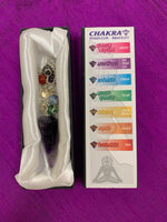 Load image into Gallery viewer, Amethyst pendulum with silver-colored chain, accented by 7 chakra beads is shown displayed in its white satiny lined box, displaying the names of the 7 major chakras, the color of each and the name of each chakra bead on the pendulum chain. 
