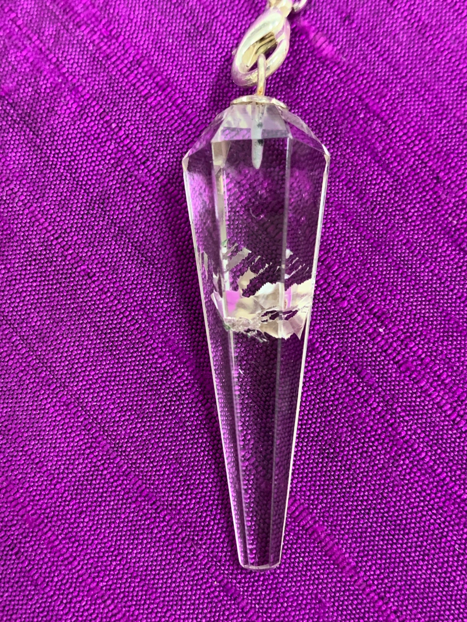 Close-up view of the clear quartz crystal (this one with an inclusion, but each pendulum's crystal is different.