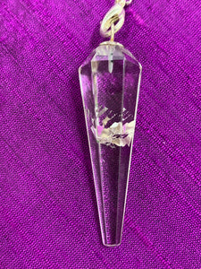 Close-up view of the clear quartz crystal (this one with an inclusion, but each pendulum's crystal is different.
