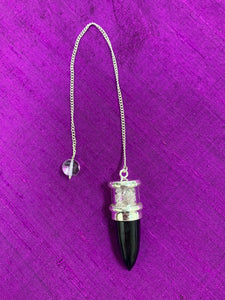 Elegant pendulum with black tourmaline gemstone set in sterling silver with Herkimer diamond chips above it, encased in glass and a clear quartz bead at the opposite end of the silver chain. Pendulums are used as divination tools for receiving information from your guides, angels and higher Self. Cost is $30.