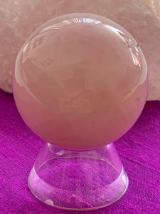Close-up view with stand. High quality Rose Quartz sphere is perfect for your altar, meditation space or to hold while meditating, or anywhere you want to radiate the energy of love ♥. Rose quartz is the "stone of unconditional love & infinite peace." It opens the heart and soothes emotional distress. Size is approximately 2"/40mm. Plastic stand as seen in photo, is included with your purchase.