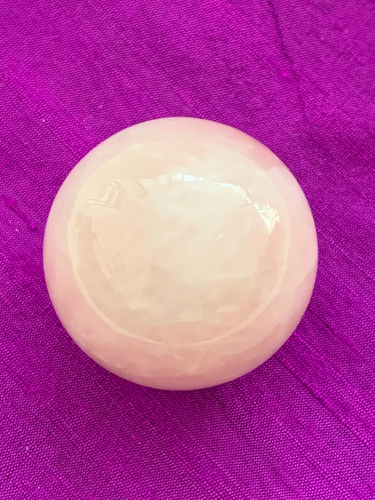 Close-up view without stand. High quality Rose Quartz sphere is perfect for your altar, meditation space or to hold while meditating, or anywhere you want to radiate the energy of love ♥. Rose quartz is the "stone of unconditional love & infinite peace." It opens the heart and soothes emotional distress. Size is approximately 2"/40mm. Plastic stand as seen in photo, is included with your purchase.
