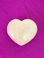 Load image into Gallery viewer, Close Up View. High quality Rose Quartz heart is perfect for your altar, meditation space or to hold while meditating, or anywhere you want to radiate the energy of love ♥. A great gift too! Rose quartz is the &quot;stone of unconditional love &amp; infinite peace.&quot; It opens the heart and soothes emotional distress. Size is approximately 40mm.
