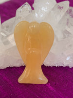 Load image into Gallery viewer, Close-up view. Lovely honey calcite angel is perfect for your altar, meditation space, to hold while meditating, or anywhere you want to cleanse, clear negative energy or increase spiritual connection. Honey calcite helps lift your energy and cleanse the atmosphere or your own personal energy. It also increases spiritual connection and psychic abilities, bringing higher energies into the body, relieving worries and bringing serenity. It eases the challenges that come with change. Size is approximately 1½&quot;.

