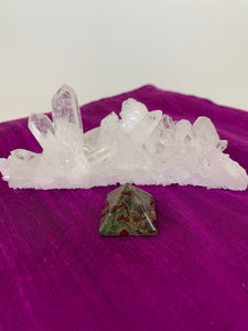 Powerful dragon blood (aka dragon stone) pyramid is perfect for your altar, meditation space or anywhere you want to radiate the energy of courage. Dragon stone jasper (a variety of quartz) is a stone of strength, courage and personal power. It enhances creativity and also attracts both money and love (themagicisinyou.com). It is also said to increase fertility. Size is approximately1"x1". 