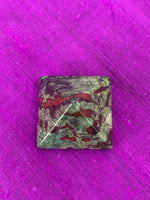 Load image into Gallery viewer, Close-up view from above. Powerful dragon blood (aka dragon stone) pyramid is perfect for your altar, meditation space or anywhere you want to radiate the energy of courage. Dragon stone jasper (a variety of quartz) is a stone of strength, courage and personal power. It enhances creativity and also attracts both money and love (themagicisinyou.com). It is also said to increase fertility. Size is approximately1&quot;x1&quot;.
