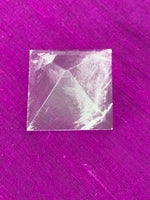 Load image into Gallery viewer, Close-up view from above. Powerful clear quartz pyramid is perfect for your altar, meditation space or anywhere in your home or office. This pyramid is cloudy or milky in appearance - more translucent than the other clear quartz pyramids. So, the clear vs the cloudy - it&#39;s all in the eye of the beholder ;). Quartz is the &quot;most powerful healing and energy amplifier on the planet&quot; (Judy Hall).  Pyramids are used to amplify and transform energy. Approximately 1&quot;x1&quot;.
