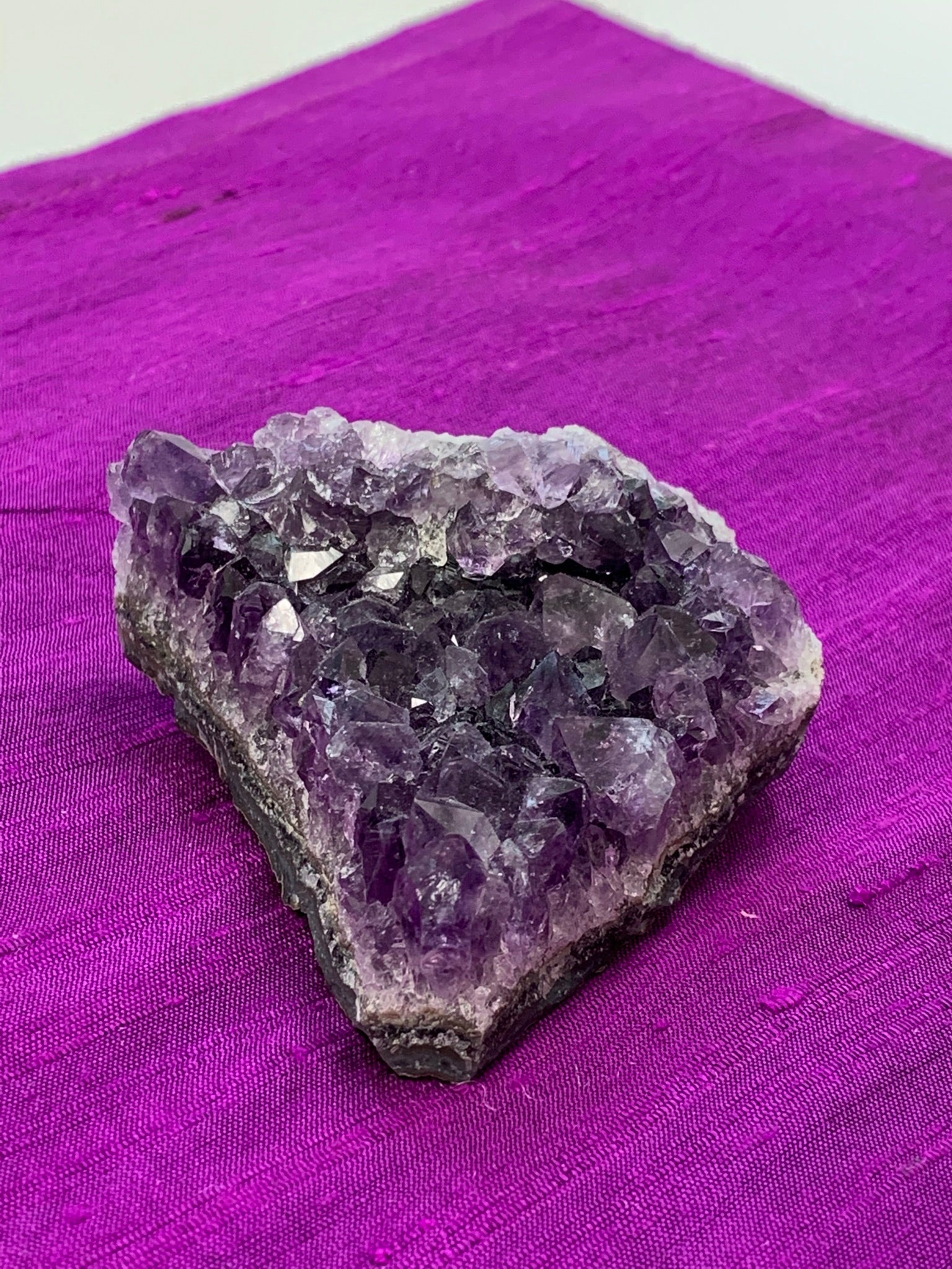 close-up view of amethyst geode piece - great quality and color. Size varies, but the average weight is 4.4oz. Each piece is unique in shape.