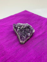 Load image into Gallery viewer, Amethyst geode piece - great quality and color. Size varies, but the average weight is 4.4oz. Each piece is unique in shape.
